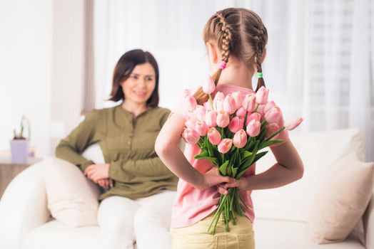 Caring girl is preparing really nice surprise for mom on holiday