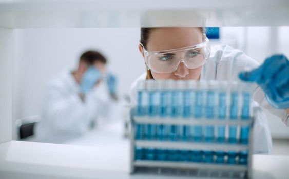 close up.scientist with vial doing research in clinical laboratory