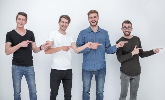 cheerful group of friends showing their fingers to the side .isolated on white background