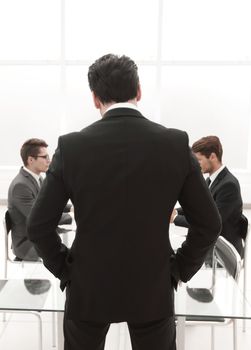 rear view.businessman standing in the conference room.business concept