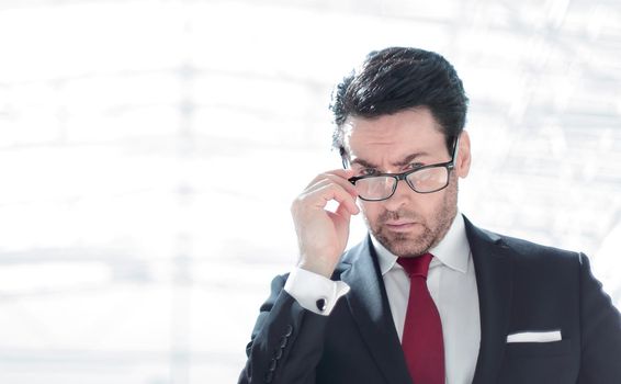 serious businessman looks over his glasses .photo with copy space