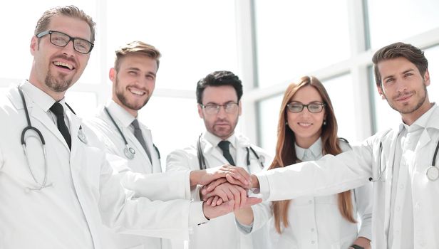 group of doctors with their hands folded together.the concept of health