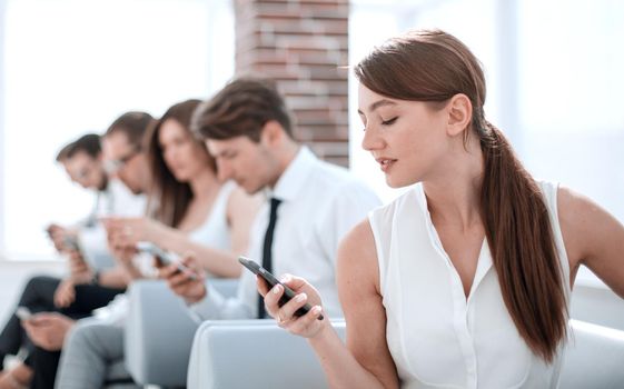 young employee looking at text message on smartphone.photo with copy space