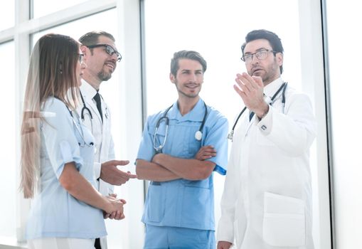 leading doctor talking with hospital staff. photo with text space