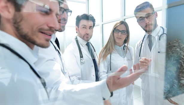 close up.a group of doctors discussing the patient's x-ray