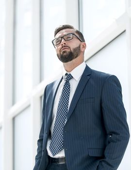 serious businessman standing in a spacious office.photo with text space