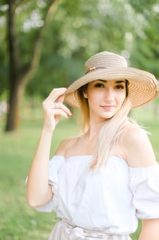 Portrait of young pretty caucasian girl wearing hat and smiling. Concept of beauty, female person and summer fashion.