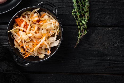 Homemade sauerkraut with cumin set, on black wooden table background, top view flat lay , with space for text copyspace