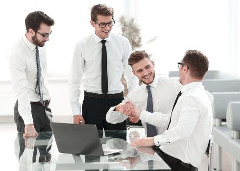 happy employees shaking hands .success concept