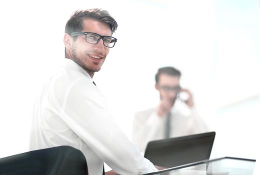 rear view.employees sitting at the office Desk.business background.