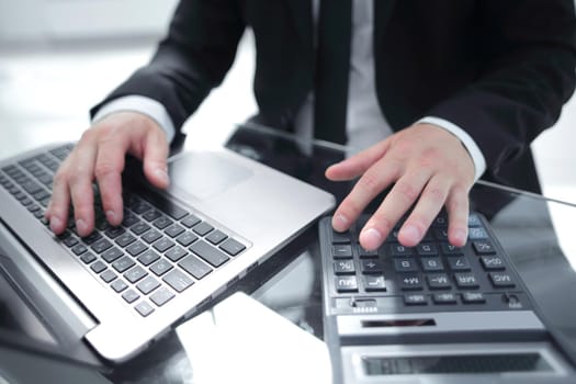 close-up of a finger of a man working a touch-sensitive keyboard on a laptop