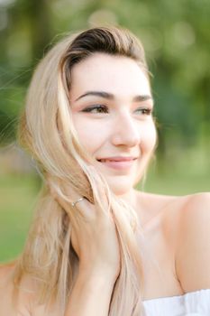 Portrait of young pretty girl, green background. Concept of beauty and everyday makeup.