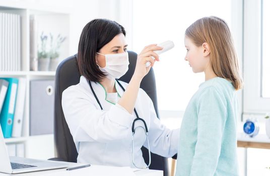 Measuring temperature of little girl in doctor's office