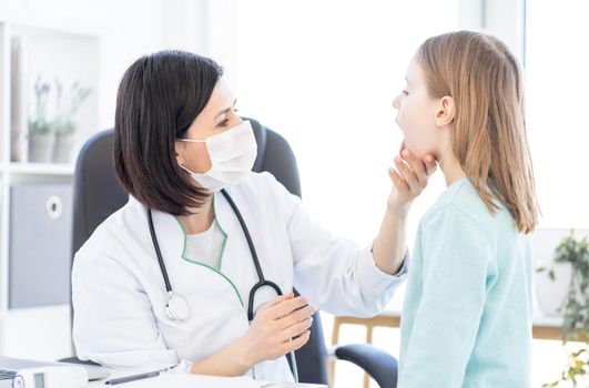 Doctor examining little girl in clinic