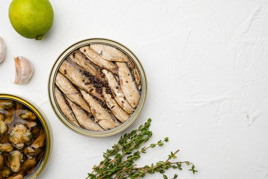 Tin can of sprats, sardines set, on white stone table background, top view flat lay, with copy space for text