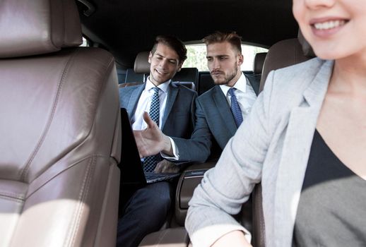 smiling business woman in a prestigious car. business-trip