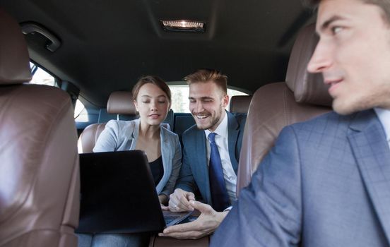 close up.business colleagues discuss business issues sitting in the car.business trip