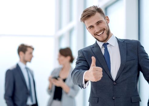 young businessman showing thumb up.photo with space for text