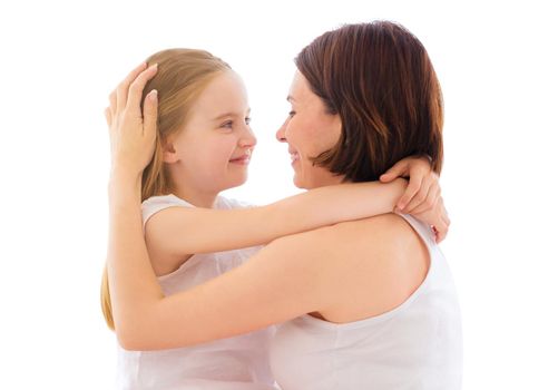 Mother with her little daughter girl tender hugging isolated on a white background