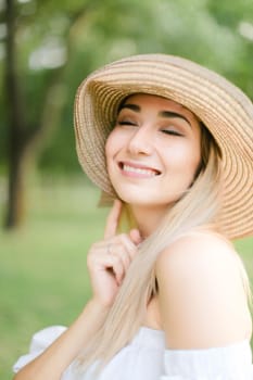 Portrait of young cute caucasian girl wearing hat and smiling. Concept of beauty, female person and summer fashion.