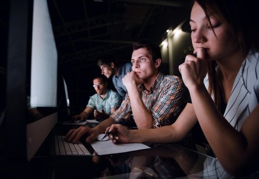 serious business team looking at their computer monitors. business concept