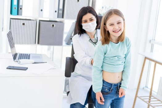 Laughing little girl during appointment with doctor