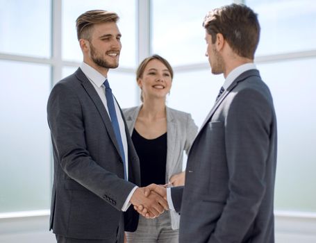 young business partners shaking hands.concept of cooperation