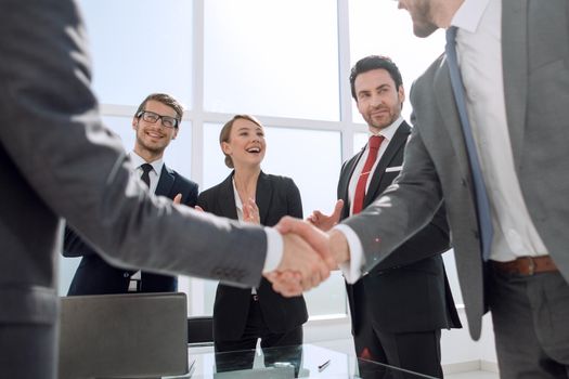 handshake business partners standing in the office.concept of partnership