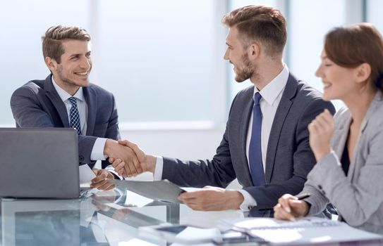 handshake business partners sitting at the table.concept of cooperation