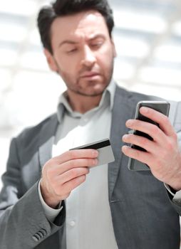 close up.businessman dialing the number on the smartphone. the concept of telephony