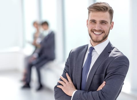 successful businessman on the background of a bright office.business people