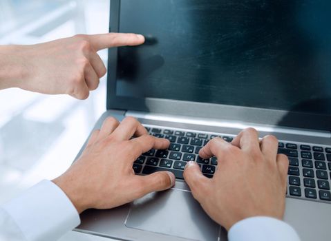 Close up of male hands using computer on the desk.