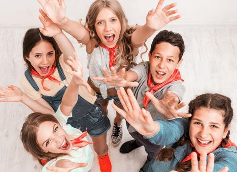 laughing happy children with hands up, top view