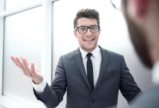 young businessman talking standing in the office.business concept