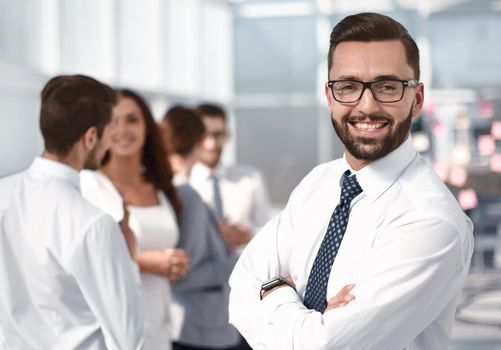 portrait of a successful businessman on the background of the office . business people