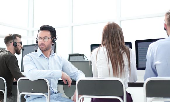 rear view.operator communication in the workplace in the call center.photo with copy space