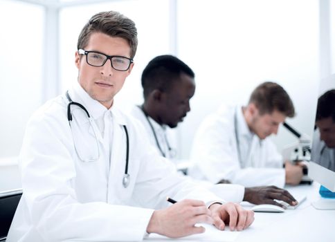 experienced doctor sitting at the laboratory table.the concept of health