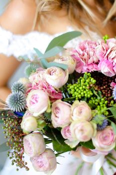 Close up wonderful bridal bouquet in bride hands. Concept of floristic art and wedding photo session.