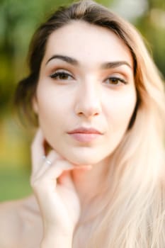 Close up portrait of young gorgeous girl, green background. Concept of beauty and everyday makeup.