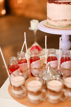 Tasty birthday cake and yummy home made drinks on table. Concept of delicious sweets and celebrating party.