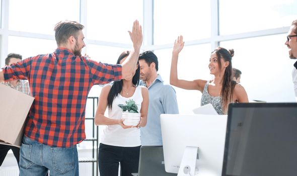 business team is giving each other a high five in the new office.photo with copy space
