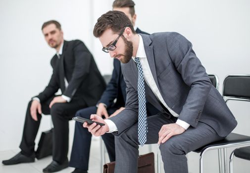 group of business people waiting for a meeting sitting in the office reception.photo with text space