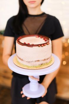 Caucasian girl keeping birthday cake with copy space. Concept of celebreating party and sweet food.