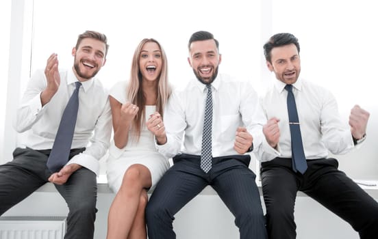 close up.happy business team sitting in a row.the concept of teamwork