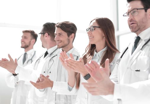 group of successful doctors applauds. the concept of good work