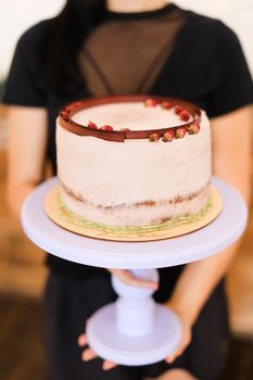 Girl keeping birthday cake with copy space. Concept of celebreating party and sweet food.