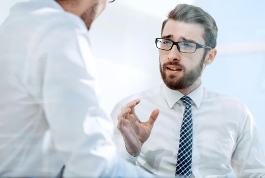 close up.two employees discussing a new business plan.photo with copy space