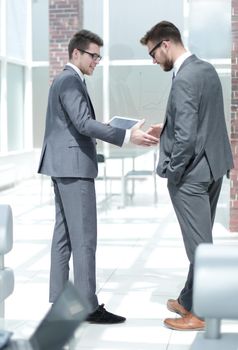 handshake two employees standing in the office . business concept