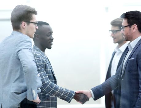 handshake of international business partners at the meeting in the office.