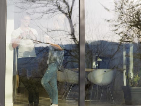 romantic happy young couple enjoying morning coffee by the window in their luxury home